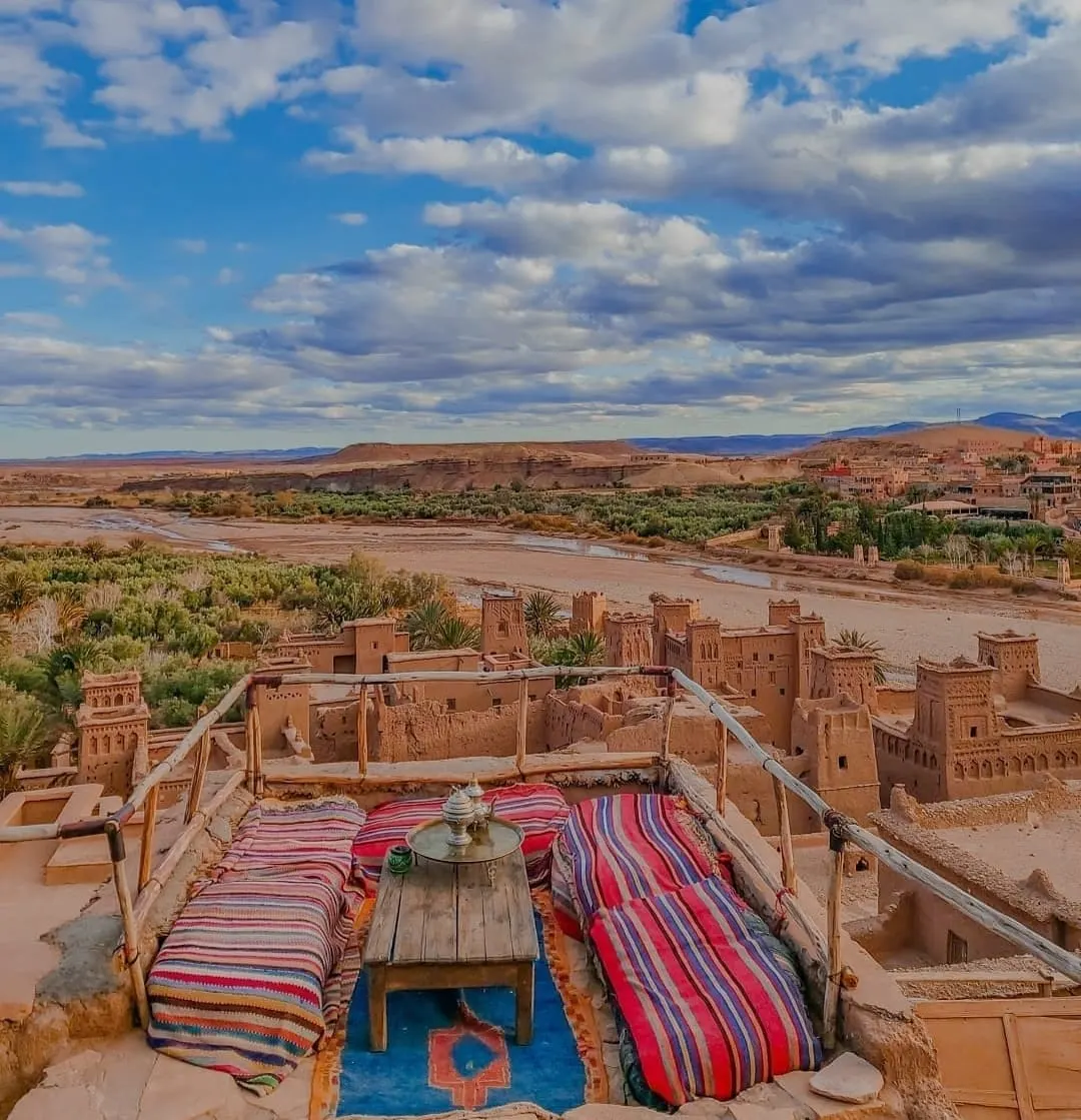Terraza con cojines de colores frente al paisaje de Ait Ben Haddou